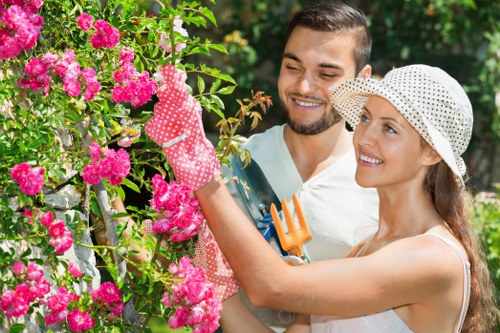 Gardener working in a Dulwich garden planting seasonal beds
